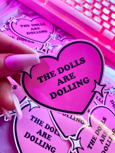 THE DOLLS ARE DOLLING STICKER