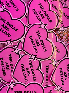 THE DOLLS ARE DOLLING STICKER